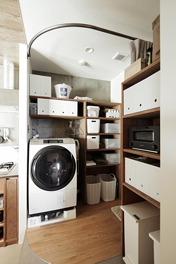 （写真10）キッチン横にはランドリースペース兼脱衣室を配置。下着やパジャマ類などお風呂上がりに着替えるものは、乾燥機から取り出してそのまま脱衣所に収納できるようにしています。